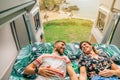 Couple looking at each other lying on the bed of their camper van Royalty Free Stock Photo
