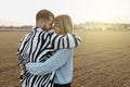 Happy couple looking each other and touching noses in countryside at sunset. Girlfriend and boyfriend Royalty Free Stock Photo