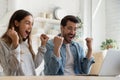 Happy couple looking at laptop screen celebrate online lottery victory Royalty Free Stock Photo