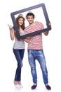 Happy couple looking through tablet frame Royalty Free Stock Photo