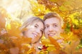 Happy couple in love in autumn yellow leaves. Portrait of young woman and man in fall. Love, relationship, family, romantic. Royalty Free Stock Photo