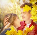 Happy couple in love in autumn yellow maple leaves. Sensual portrait of young woman and man in fall. Love, relationship, family. Royalty Free Stock Photo