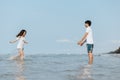 Happy couple in love on the beach. Woman running into men`s embrace on the beach Royalty Free Stock Photo