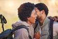 Happy couple, love and black people hiking in sunrise kissing and hugging outdoors after workout, fitness and exercise Royalty Free Stock Photo