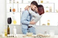 Happy Couple in love cooking dough and kissing in kitchen Royalty Free Stock Photo