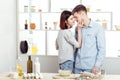 Happy Couple in love cooking dough and kissing in kitchen Royalty Free Stock Photo