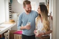 Happy couple in love drinking morning coffee at home