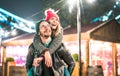 Happy couple in love enjoying winter travel time outdoor - Handsome guy with nice girl on piggy back moment - Relationship concept