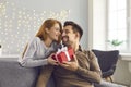 Happy young man holding Valentine gift, smiling and thanking his girlfriend for present Royalty Free Stock Photo