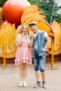 Happy couple in love having fun in an amusement park, eating lollipops Royalty Free Stock Photo