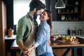 Happy couple in love having fun in kitchen at home Royalty Free Stock Photo