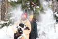 Happy couple in love having fun in the snow with his baby dog Royalty Free Stock Photo