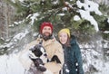 Happy couple in love having fun in the snow with his baby dog Royalty Free Stock Photo