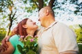 Happy couple in love having romantic date outdoors looking at each other and smiling, man gave his woman he loves Royalty Free Stock Photo