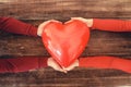 Happy couple in love holding red heart shaped balloon. Valentine day and romance concept. Royalty Free Stock Photo