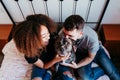 happy couple in love at home. Afro american woman, caucasian man and their pit bull dog together. Family concept Royalty Free Stock Photo