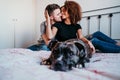 happy couple in love at home. Afro american woman, caucasian man and their pit bull dog together. Family concept Royalty Free Stock Photo