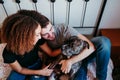 happy couple in love at home. Afro american woman, caucasian man and their pit bull dog together. Family concept Royalty Free Stock Photo