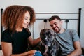 happy couple in love at home. Afro american woman, caucasian man and their pit bull dog together. Family concept Royalty Free Stock Photo