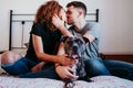 happy couple in love at home. Afro american woman, caucasian man and their pit bull dog together. Family concept Royalty Free Stock Photo