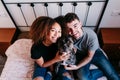 happy couple in love at home. Afro american woman, caucasian man and their pit bull dog together. Family concept Royalty Free Stock Photo