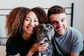 happy couple in love at home. Afro american woman, caucasian man and their pit bull dog together. Family concept Royalty Free Stock Photo