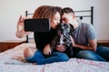 happy couple in love at home. Afro american woman, caucasian man and their pit bull dog together. Family concept Royalty Free Stock Photo