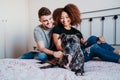 Happy couple in love at home. Afro american woman, caucasian man and their pit bull dog together. Family concept Royalty Free Stock Photo