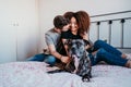 happy couple in love at home. Afro american woman, caucasian man and their pit bull dog together. Family concept Royalty Free Stock Photo