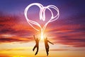 Happy couple in love jump making heart symbol of light