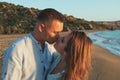 Happy couple in love kissing on the beach during sunset or sunrise. Love concept Royalty Free Stock Photo