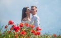 Happy couple in love kissing in beautiful field of poppy flower on romantic day, love Royalty Free Stock Photo