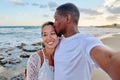 Happy couple in love kissing taking selfie together on smartphone, on beach Royalty Free Stock Photo