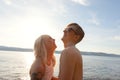 Happy couple in love laughing at the beach against sun Royalty Free Stock Photo