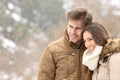 Happy couple in love looking away in winter