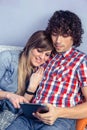 Happy couple in love looking electronic tablet on