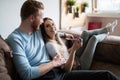 Happy couple lying on sofa together and relaxing at home Royalty Free Stock Photo