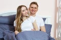 Happy couple in love on morning bed, Young loving couple in the bed, Young couple having having romantic times in bedroom Royalty Free Stock Photo