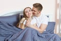 Happy couple in love on morning bed, Young loving couple in the bed, Young couple having having romantic times in bedroom Royalty Free Stock Photo