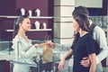 Happy couple in love paying with credit card at the jewelry stor Royalty Free Stock Photo