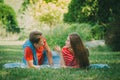 Happy couple in love resting in the park on the meadow. A pair of young people lying on the litter in the park in the summer Royalty Free Stock Photo