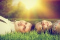 Happy couple in love smiling while lying on summer grass Royalty Free Stock Photo