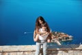 Happy couple in love summer vacations. Young man piggybacking his beautiful girlfriend over sea, while laughing at camera. Sveti S Royalty Free Stock Photo