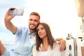 Happy couple in love taking selfie on sailing boat, relaxing on a yacht at the sea. Royalty Free Stock Photo