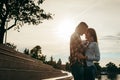 Happy couple in love tenderly hugging and rubbing noses during the sunset. Royalty Free Stock Photo