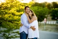 Happy couple in love together in park landscape on sunset with woman pregnant belly and man Royalty Free Stock Photo