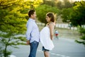 Happy couple in love together in park landscape on sunset with woman pregnant belly and man Royalty Free Stock Photo