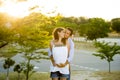 Happy couple in love together in park landscape on sunset with woman pregnant belly and man Royalty Free Stock Photo