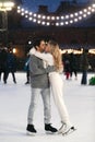 Happy couple of lovers having fun hugging an kissing at ice skating rink outdoor. St. Valentines Day Royalty Free Stock Photo