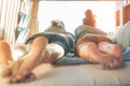 Happy couple lying on bed inside minivan looking at sunset - Travel people having tender moments during a road trip Royalty Free Stock Photo